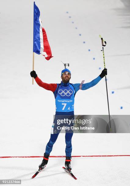 Martin Fourcade of France celebrates after crossing the finish line to win the gold medal during the Biathlon 2x6km Women + 2x7.5km Men Mixed Relay...
