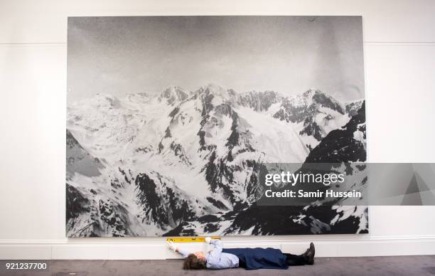 Rudolf Stingel's monumental painting of the Tyrolean Alps in Italy, based on a historic photograph, is prepared for exhibition at Sotheby's in...