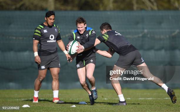 Maynooth , Ireland - 20 February 2018; Kieran Marmion is tackled by Jacob Stockdale during Ireland Rugby squad training at Carton House in Maynooth,...