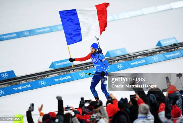 Martin Fourcade of France celebrates winning the gold medal during the Biathlon 2x6km Women + 2x7.5km Men Mixed Relay on day 11 of the PyeongChang...