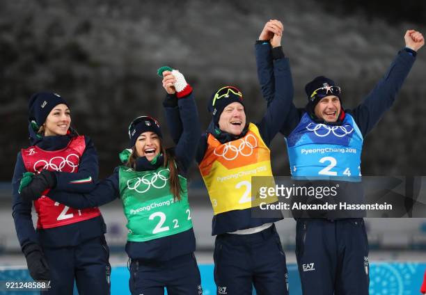 Bronze medalists Lisa Vittozzi, Dorothea Wierer, Lukas Hofer and Dominik Windisch of Italy celebrate during the victory ceremony after the Biathlon...