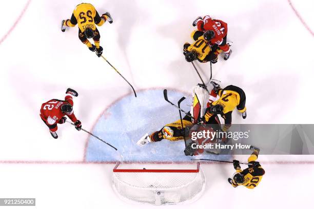 Simon Moser of Switzerland shoots and scores against Danny Aus Den Birken of Germany in the second period during the Men's Ice Hockey Qualification...