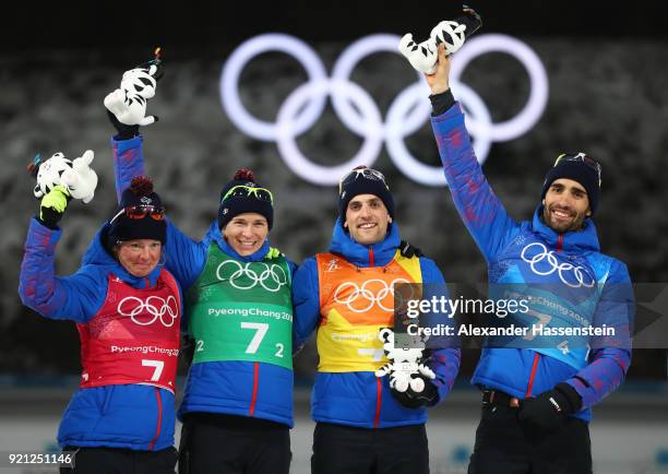 Gold medalists Marie Dorin Habert, Anais Bescond, Simon Desthieux and Martin Fourcade of France celebrate during the victory ceremony after the...