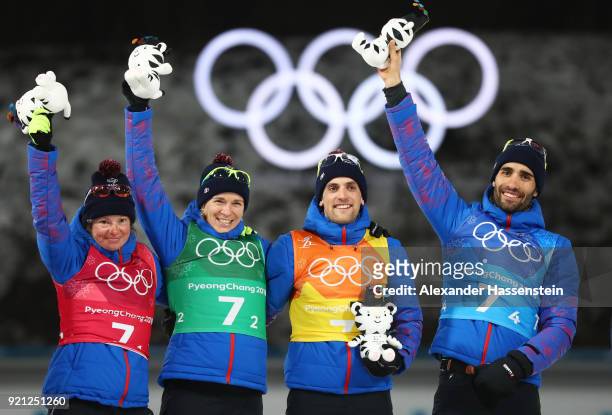 Gold medalists Marie Dorin Habert, Anais Bescond, Simon Desthieux and Martin Fourcade of France celebrate during the victory ceremony after the...