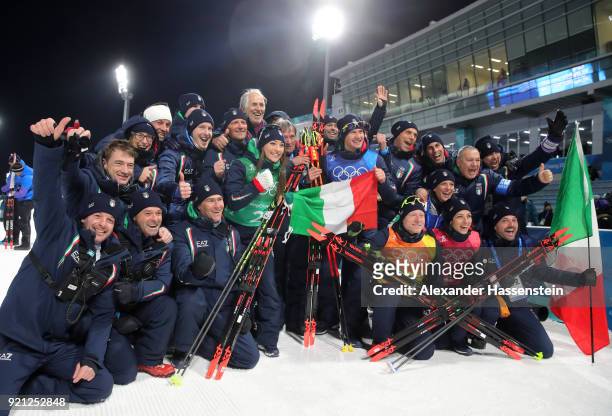 Bronze medalists Lisa Vittozzi, Dorothea Wierery, Dominik Windisch and Lukas Hofer of Italy celebrate with their team after the victory ceremony for...