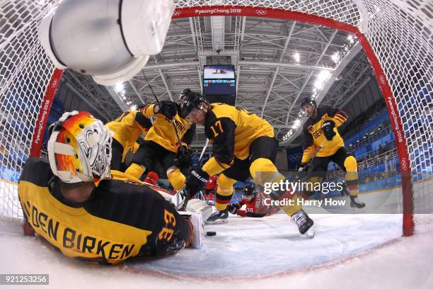 Danny Aus Den Birken of Germany makes a save against Raphael Diaz and Denis Hollenstein of Switzerland in the first period during the Men's Ice...