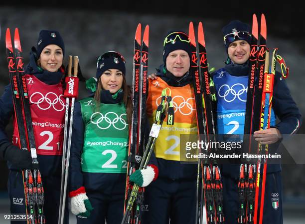 Bronze medalists Lisa Vittozzi, Dorothea Wierer, Lukas Hofer and Dominik Windisch of Italy celebrate during the victory ceremony after the Biathlon...