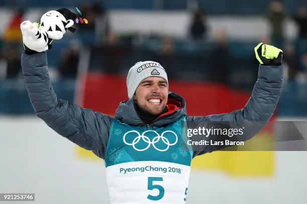 Johannes Rydzek of Germany celebrates winning the gold medal during the victory ceremony for the Nordic Combined Individual Gundersen 10km...