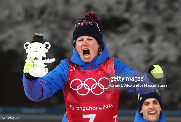 Gold medalist Marie Dorin Habert of France celebrates during the victory ceremony after the Biathlon 2x6km Women + 2x7.5km Men Mixed Relay on day 11...