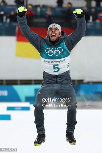 Johannes Rydzek of Germany celebrates winning the gold medal during the victory ceremony for the Nordic Combined Individual Gundersen 10km...