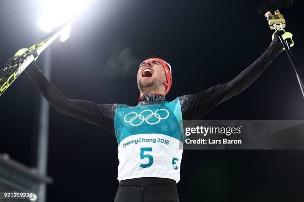 Johannes Rydzek of Germany celebrates winning the gold medal during the Nordic Combined Individual Gundersen 10km Cross-Country on day eleven of the...