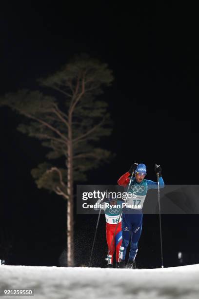 Francois Braud of France and Tomas Portyk of the Czech Republic compete during the Nordic Combined Individual Gundersen 10km Cross-Country on day...