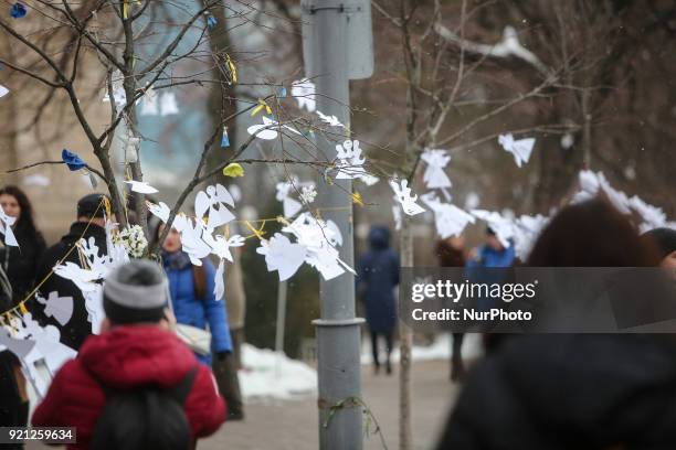 Paper cutted angels are seen hanging along the Instytutska street which saw the worst violence during the revolution. Ukraine pays tribute to the...