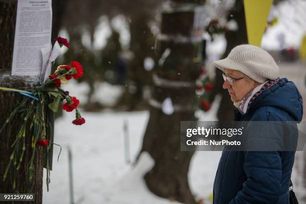 Woman prays near the place where protester were shot at the Instytutska street which saw the worst violence during the revolution. Ukraine pays...