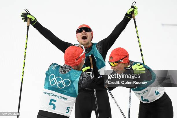 Bronze medallist Eric Frenzel of Germany congratulates gold medallist Johannes Rydzek of Germany as silver medallist Fabian Riessle of Germany...