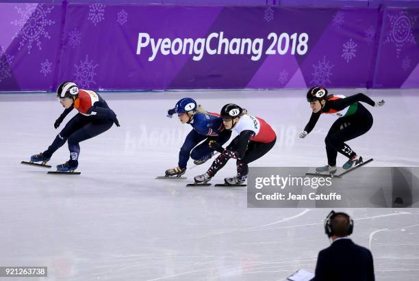 Elise Christie of Great Britain receives a second penalty and is disqualified for pushing Magdalena Warakomska of Poland while Lara Van Ruijven of...