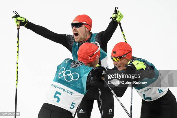 Bronze medallist Eric Frenzel of Germany congratulates gold medallist Johannes Rydzek of Germany as silver medallist Fabian Riessle of Germany...