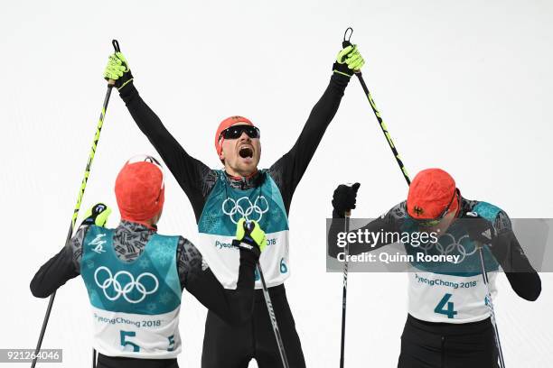 Bronze medallist Eric Frenzel of Germany congratulates gold medallist Johannes Rydzek of Germany as silver medallist Fabian Riessle of Germany...