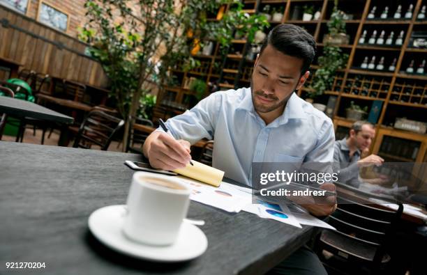 manager doing the books at a restaurant - coffee plant stock pictures, royalty-free photos & images