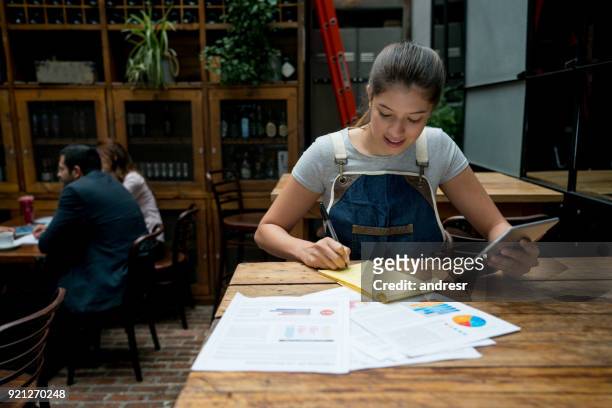 happy man doing the books at a restaurant - business plan stock pictures, royalty-free photos & images