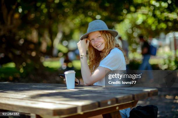 young woman taking a break and drink coffee in the park - summer of 77 stock pictures, royalty-free photos & images