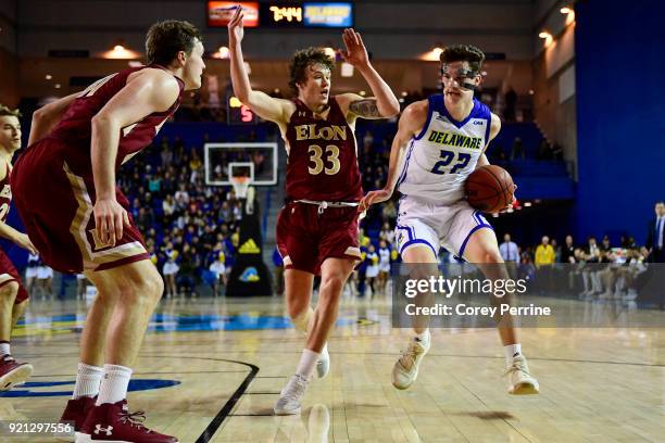 Jacob Cushing of the Delaware Fightin Blue Hens dribbles against Simon Wright of the Elon Phoenix during the first half at the Bob Carpenter Center...