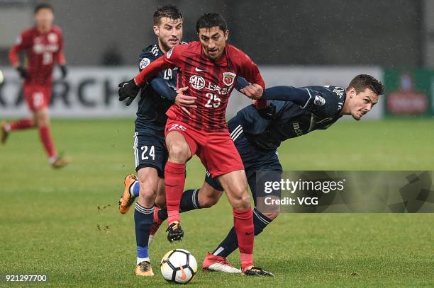 Terry Antonis, James Donachie of Melbourne Victory and Odil Ahmedov of Shanghai SIPG compete for the ball during the 2018 AFC Champions League Group...