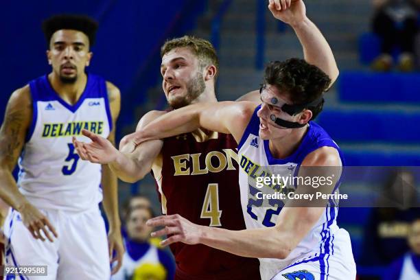 Jacob Cushing of the Delaware Fightin Blue Hens fouls Collin Luther of the Elon Phoenix during the second half at the Bob Carpenter Center on...