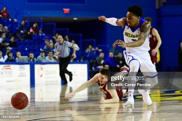 Anthony Mosley of the Delaware Fightin Blue Hens eyes the ball as Seth Fuller of the Elon Phoenix loses his footing after making contact during the...