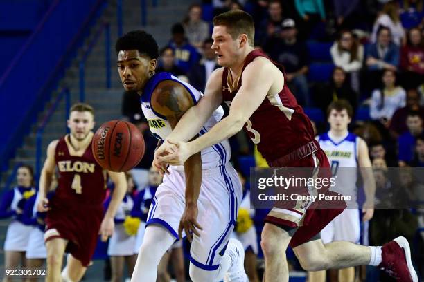 Anthony Mosley of the Delaware Fightin Blue Hens and Seth Fuller of the Elon Phoenix vie for the ball during the first half at the Bob Carpenter...