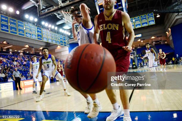 Collin Luther of the Elon Phoenix is the last to touch the ball as it lands out of bounds against Jacob Cushing of the Delaware Fightin Blue Hens...