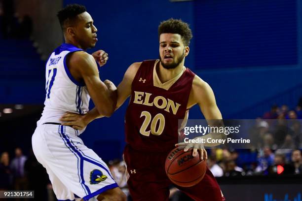 Sheldon Eberhardt of the Elon Phoenix dribbles against Chyree Walker of the Delaware Fightin Blue Hens during the second half at the Bob Carpenter...