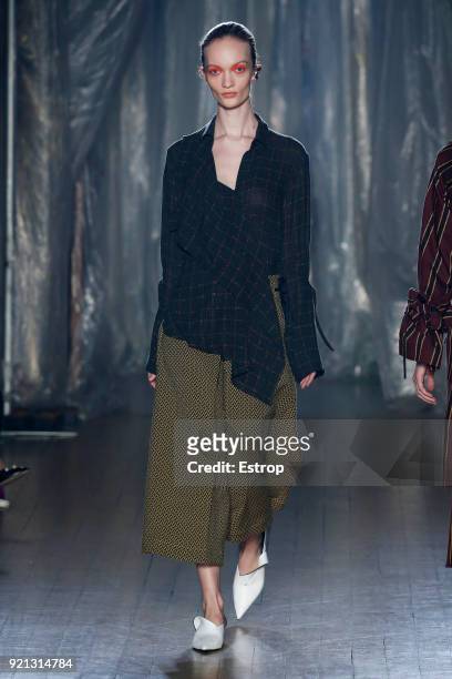 Model walks the runway at the palmer//harding show during London Fashion Week February 2018 at on February 18, 2018 in London, England.