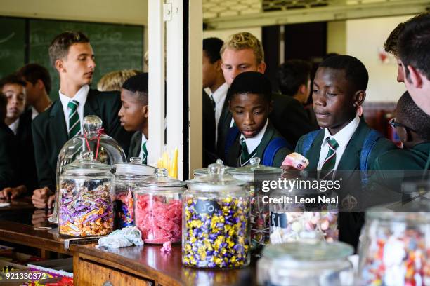 Students from the King Edward VII school queue for sweets and snacks at the tuck shop on March 29, 2017 in Johannesburg, South Africa. Those born...