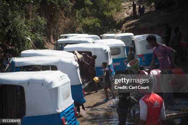 Auto rickshaws are cleaned in a stream on January 27, 2017 in Shashamane, Ethiopia. Guide book publisher Lonely Planet recently ranked Ethiopia among...