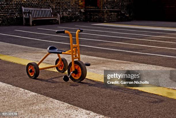 orange tricycle - tricycle stock-fotos und bilder