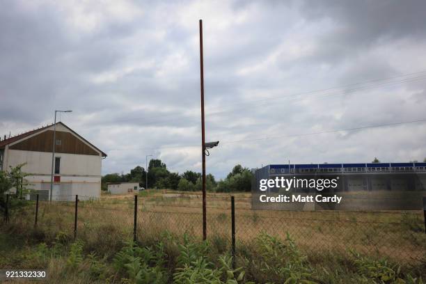 Camera looks over the old migrant reception centre on July 16, 2016 in Roszke, Hungary. Last summer thousands of refugees and migrants were using the...