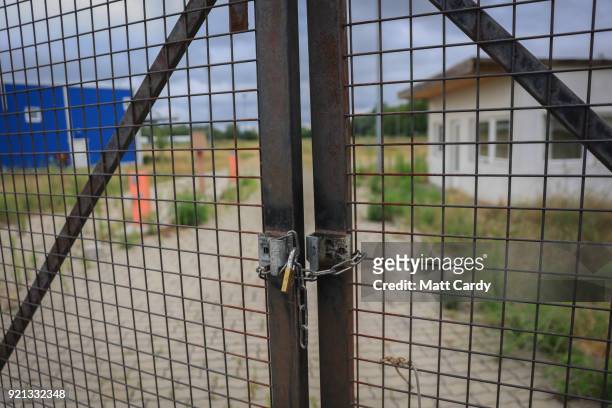 Padlock locks the gates of the old migrant reception centre on July 16, 2016 in Roszke, Hungary. Last summer thousands of refugees and migrants were...