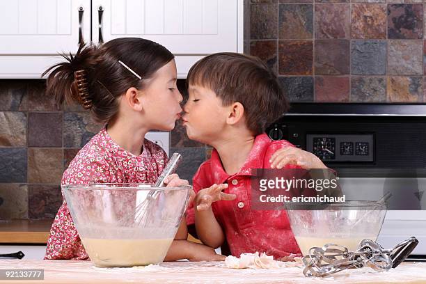 two young children kissing each other - yam pie stock pictures, royalty-free photos & images