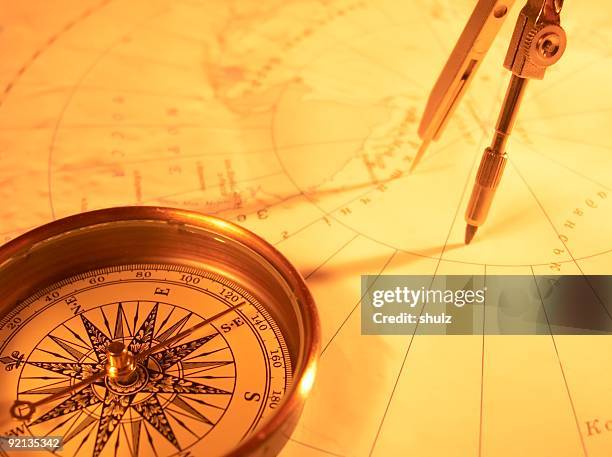 golden compass on a map with protractor  - cartograaf stockfoto's en -beelden