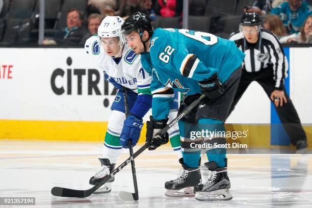 Kevin Labanc of the San Jose Sharks and Nikolay Goldobin of the Vancouver Canucks get ready at SAP Center on February 15, 2018 in San Jose,...