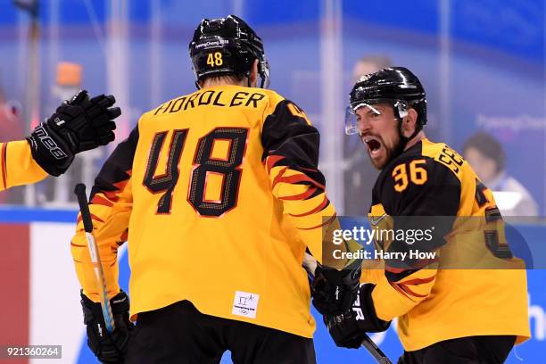 Yannic Seidenberg of Germany celebrates scoring a goal in overtime to defeat Switzerland 2-1 during the Men's Ice Hockey Qualification Playoff game...