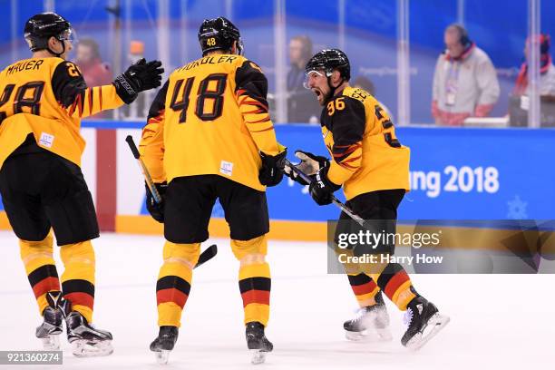 Yannic Seidenberg of Germany celebrates scoring a goal in overtime to defeat Switzerland 2-1 during the Men's Ice Hockey Qualification Playoff game...