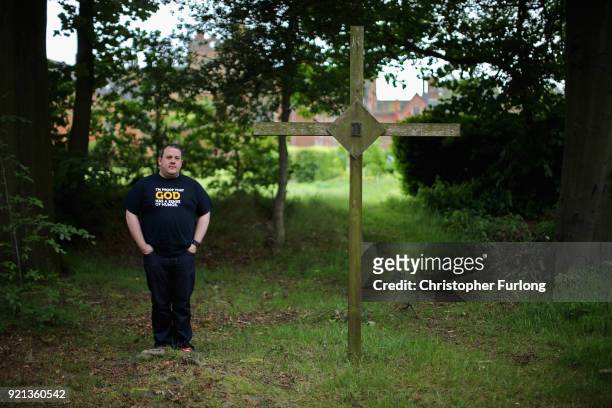 Oscott College seminarian Chris Yule poses next to one of the stations of the cross surrounding the college on May 27, 2014 in Birmingham, England....