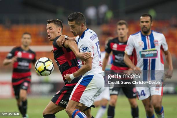 Christopher Ikonomidis of the Wanderers is tackled by Jets Daniel Georgievski during the round one A-League match between the Western Sydney...
