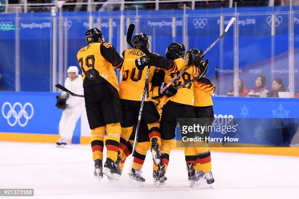 Yannic Seidenberg of Germany celebrates the game winning goal in overtime to defeat Switzerland 2-1 with Frank Mauer, Frank Hordler, David Wolf and...