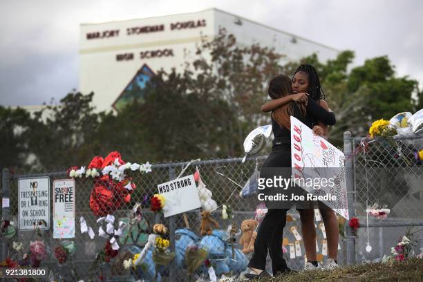 Tyra Heman a senior at Marjory Stoneman Douglas High School, is hugged by Rachael Buto in front of the school where 17 people that were killed on...
