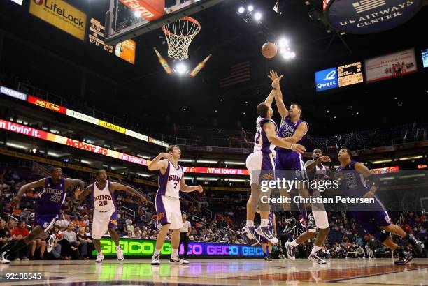 Jon Brockman of the Sacramento Kings puts up a shot over Taylor Griffin of the Phoenix Suns during the NBA preseason game at US Airways Center on...