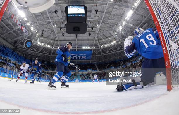 The puck shot by Ahn Jin-hui, of South Korea, flies past goalie Mikko Koskinen , of Finland, for a goal during the second period of the qualification...