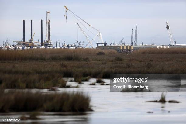 Petroleum industry cranes stand in Port Fourchon, Louisiana, U.S., on Thursday, Feb. 8, 2018. U.S. Oil explorers added rigs this week as crude prices...